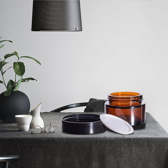 24 Pack 2 oz Round Amber Glass Cosmetic Jars with Inner Liners and Black Lids, Travel Jars, Refillable Containers for Makeup, Cream, Lotion, Sugar Scrubs, Eye Shadow, Slime, Paint, Jewelry